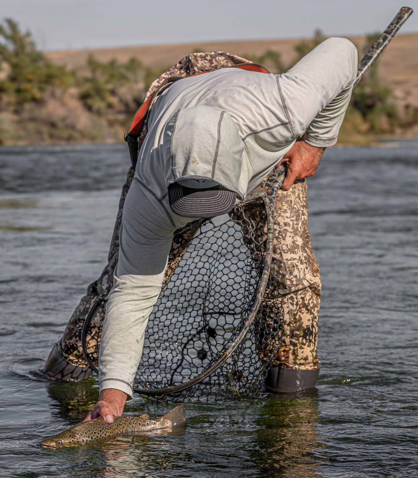 person with fish in lake